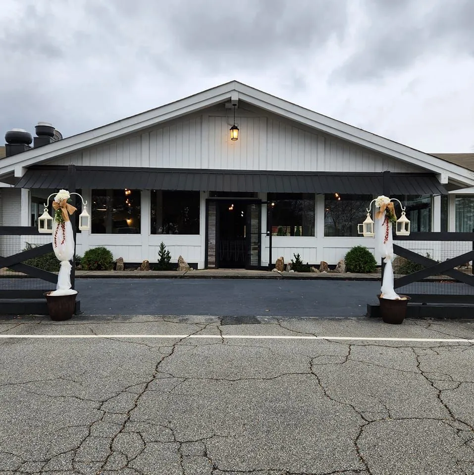 The Little Cottage event venue in Smyrna, GA — the front of the renovated painted-brick building